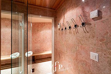 A bathroom with pink tiles and a sign that says fp