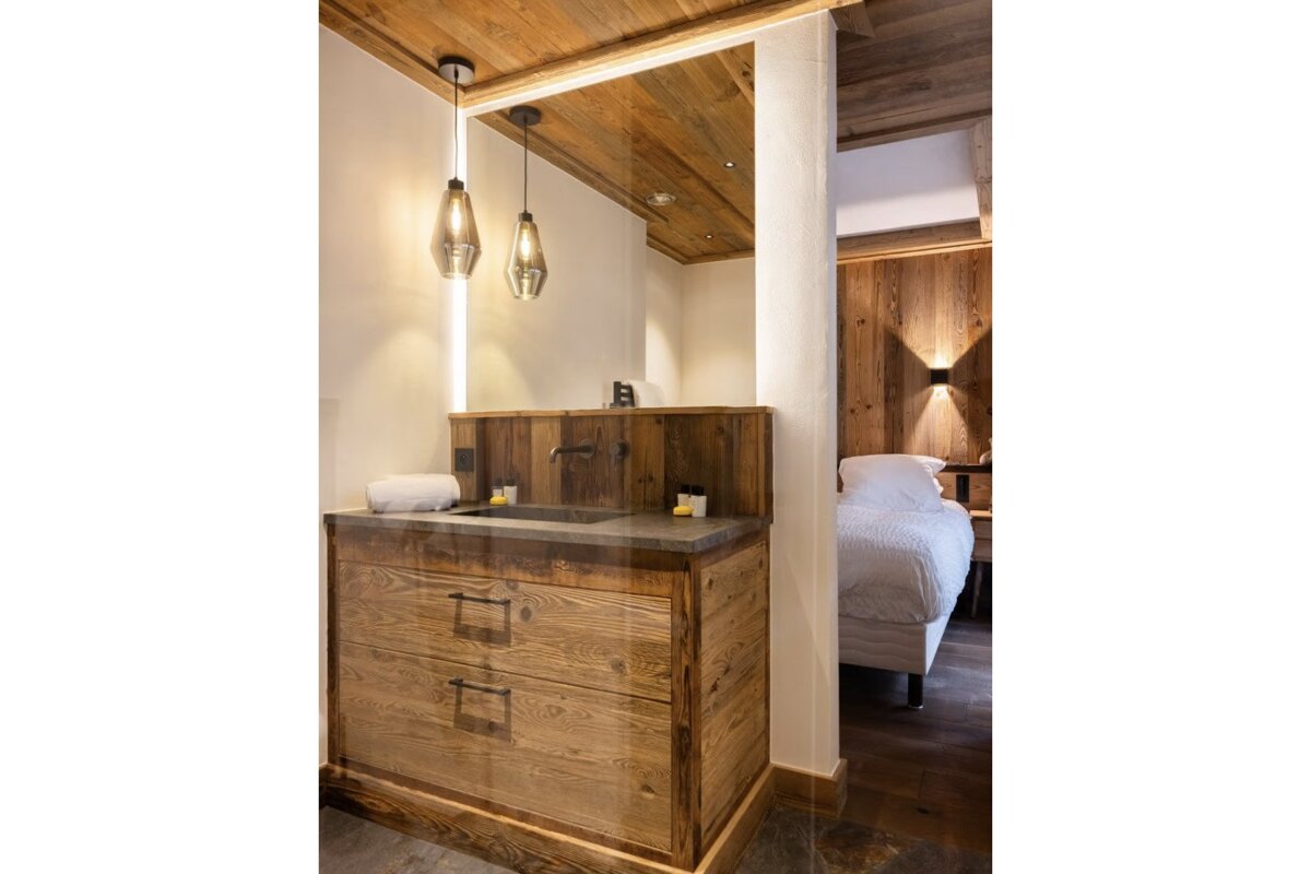 A bathroom with wooden cabinets and a sink