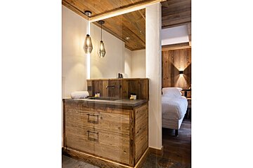 A bathroom with wooden cabinets and a sink