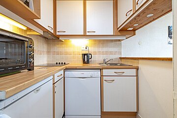 A kitchen with white cabinets and a bosch dishwasher