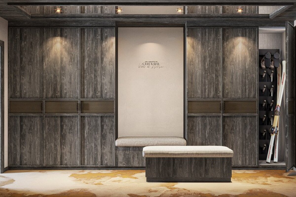 Elegant ski chalet room featuring dark wood cabinetry, built-in bench seating, and dedicated ski storage.