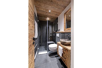 A bathroom with a toilet a sink and a mirror