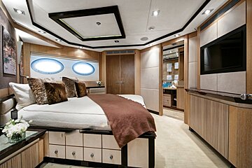A bedroom with a large bed and a flat screen tv