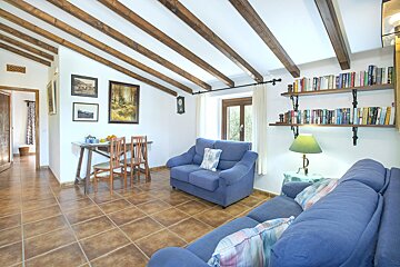 A living room with a blue couch and chairs