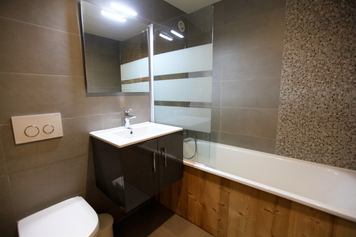 A bathroom with a toilet sink and a bathtub