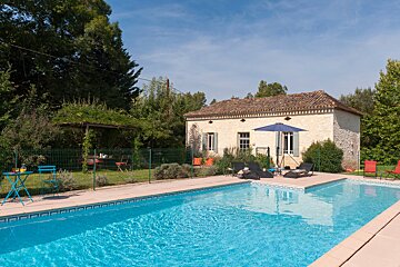 A house with a swimming pool in front of it