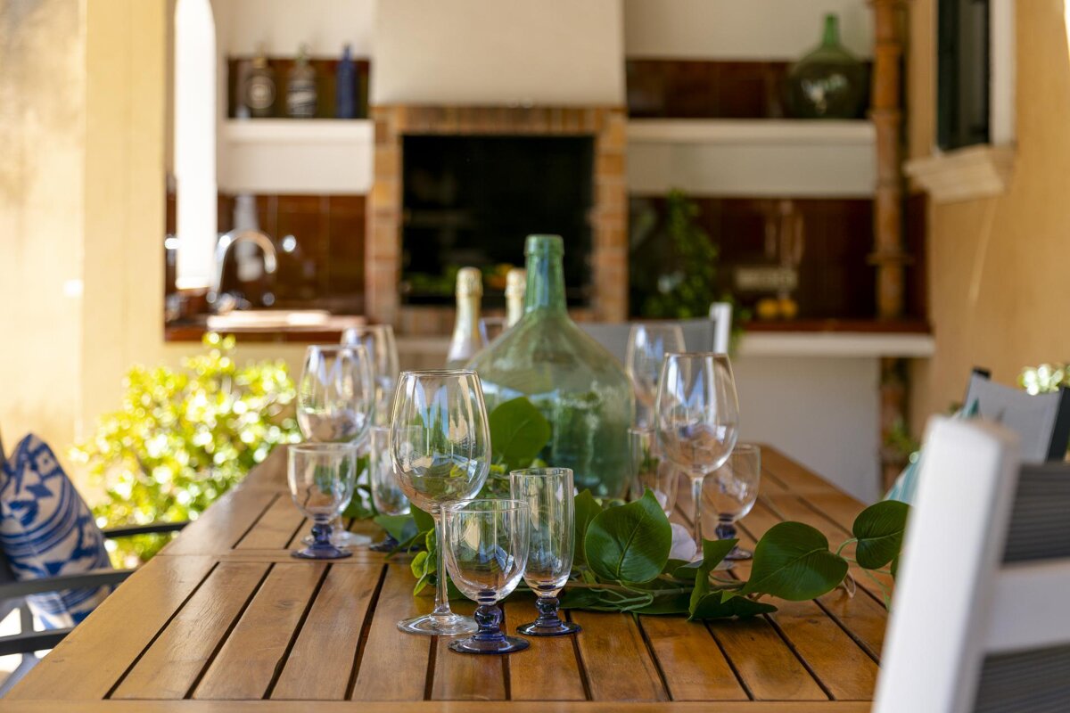 A table with wine glasses and a bottle on it