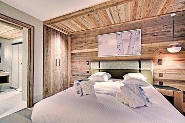 A hotel room with a bed and a picture on the wall