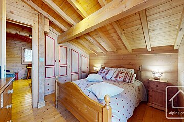 A bedroom with a bed and a sign that says alpine-pro