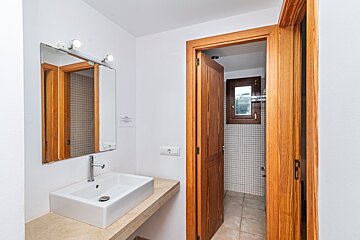 A bathroom with a sink a mirror and a door