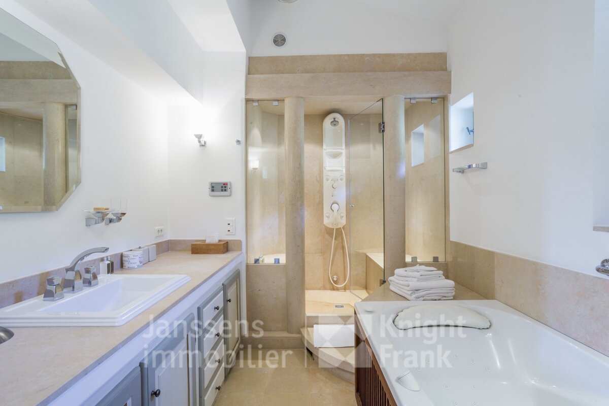 A bathroom with a sink and a bathtub and a sign that says knight frank