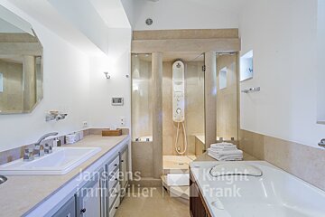 A bathroom with a sink and a bathtub and a sign that says knight frank