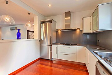 A kitchen with stainless steel appliances and white cabinets