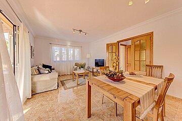 A living room with a dining table and chairs
