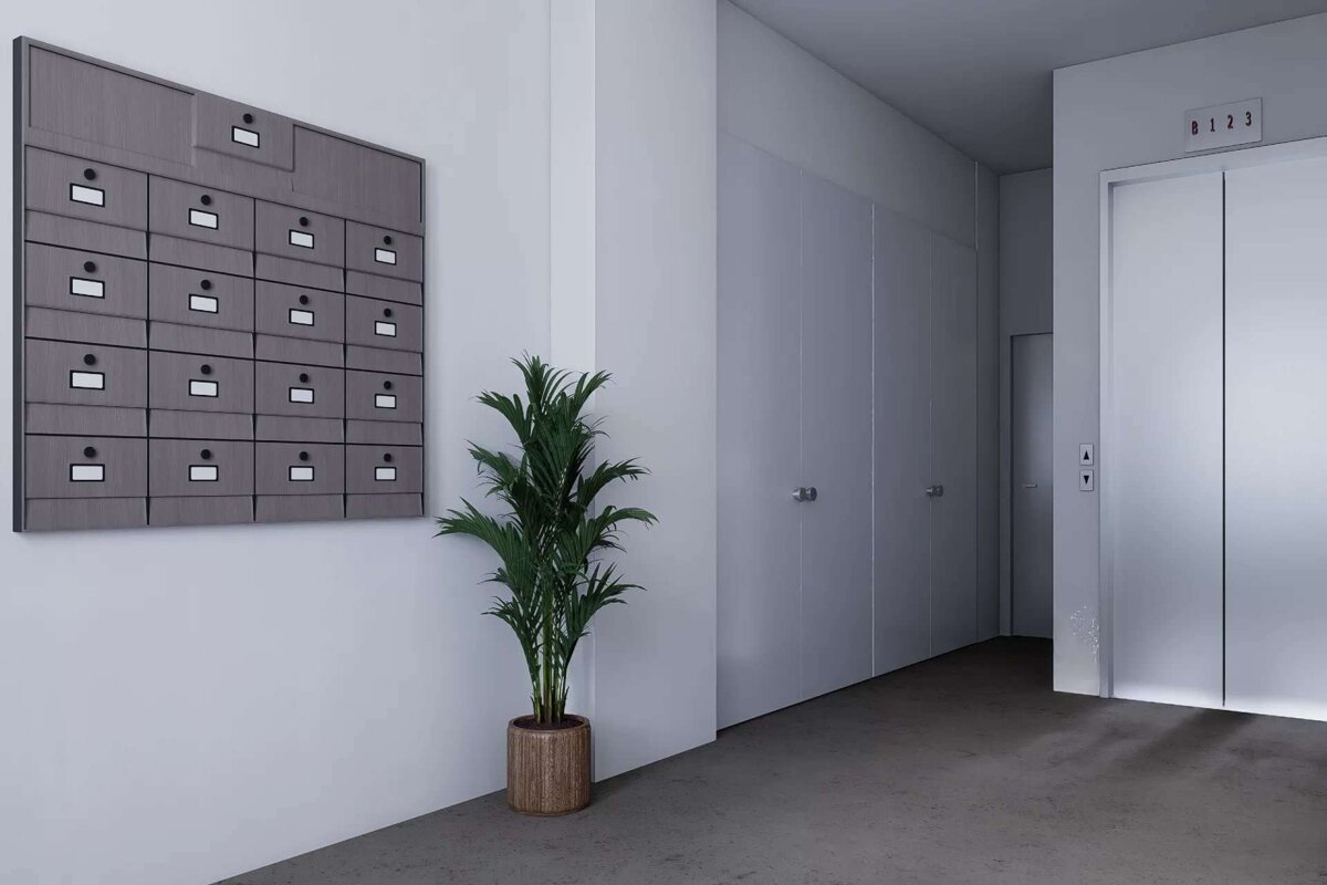 A minimalist hallway features a wall of mailboxes, a tall potted plant, multiple white doors, and a shiny elevator with a floor indicator.
