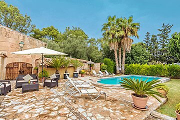 A swimming pool surrounded by chairs and umbrellas