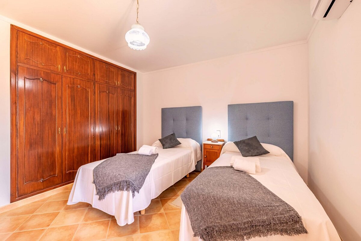 A bedroom with two beds and a large closet