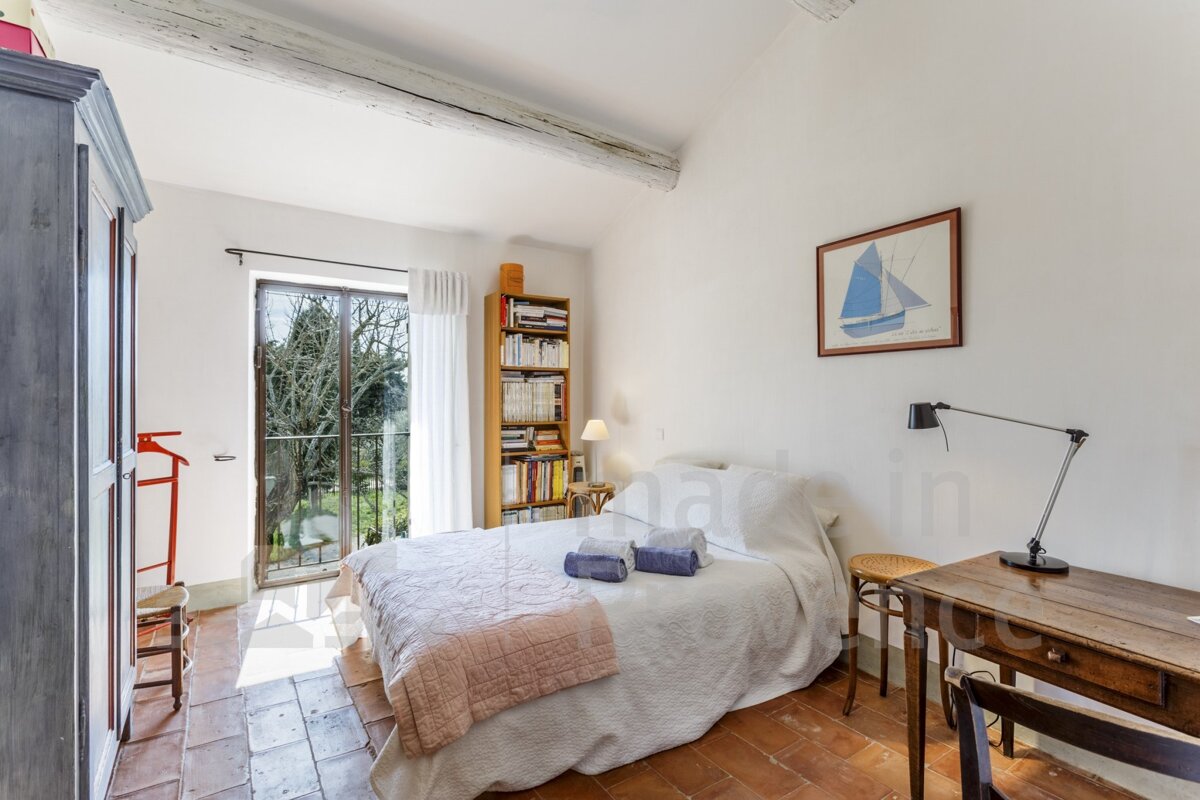 A bedroom with a picture of a sailboat on the wall