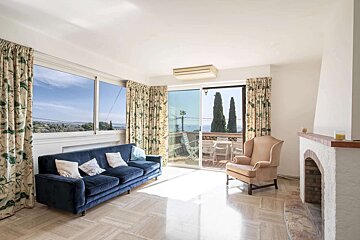 A living room with a blue couch and a yellow chair