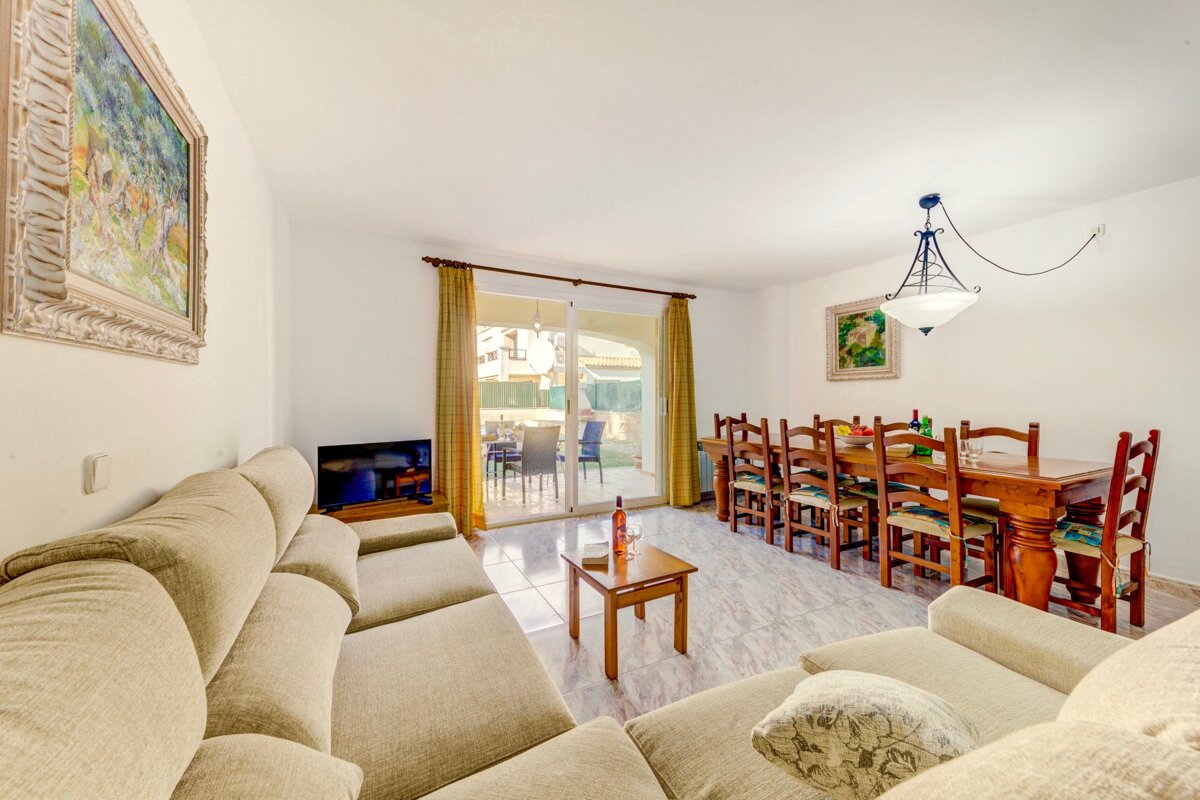 A living room with a couch a table and chairs