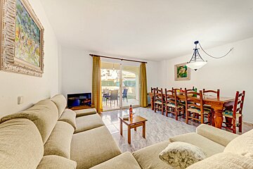 A living room with a couch a table and chairs