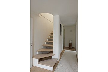 A wooden staircase leading up to the second floor
