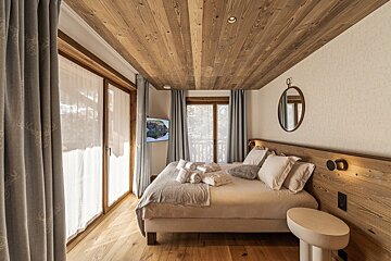 A sauna with a picture of a forest on the wall