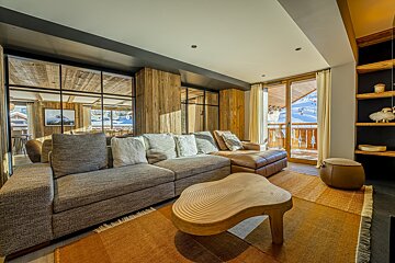 A living room with a couch and a wooden table