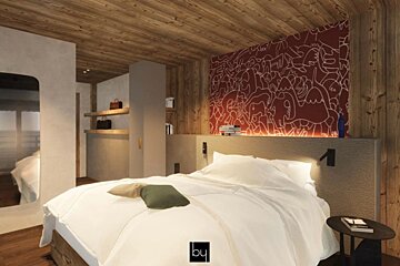 A bedroom with a bed and a wall that says by