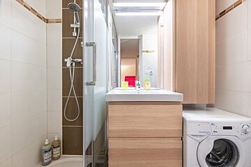 A bathroom with a washing machine that says aquafresh