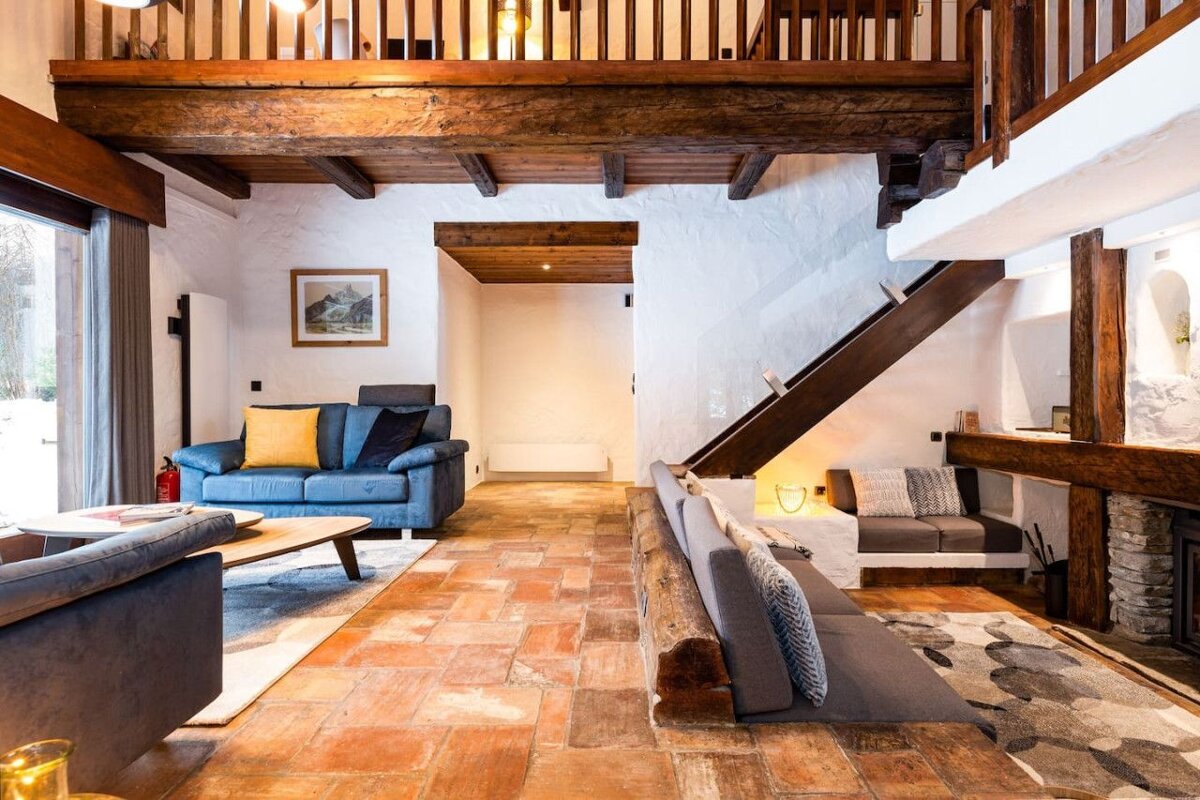 A living room with a blue couch and a picture on the wall