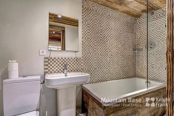 A bathroom with a sink and a bathtub with knight frank written on the bottom
