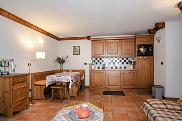 A living room with a table and chairs and a microwave