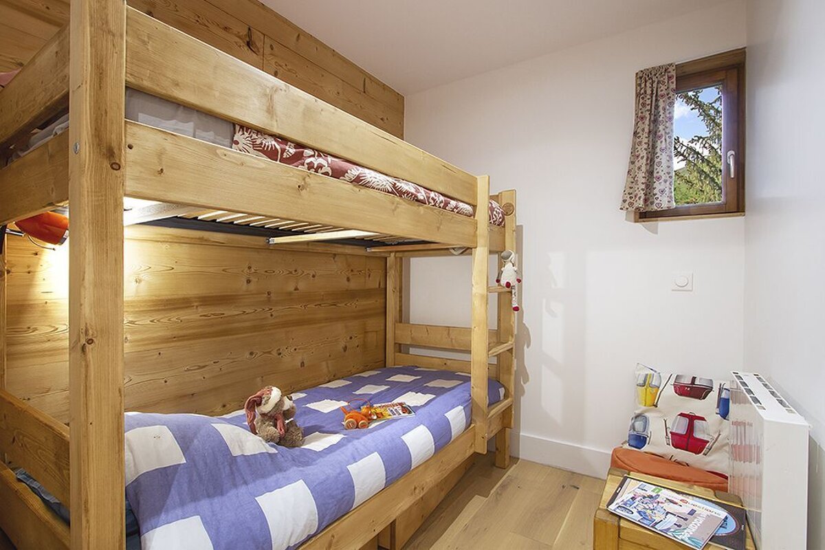 A bunk bed with a blue and white checkered blanket