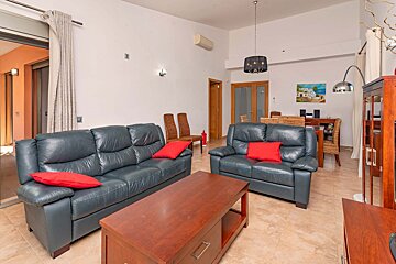 A living room with two leather couches and a coffee table