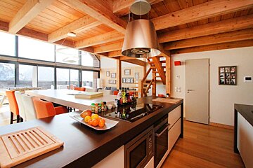 A kitchen with a large island and a stove top oven