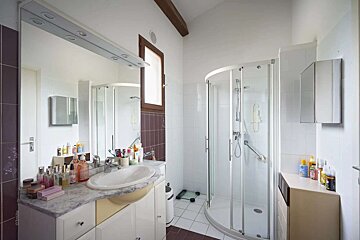 A bathroom with a sink and a walk in shower