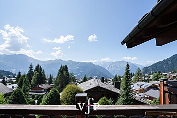 A balcony with a view of the mountains and a sign that says vjp