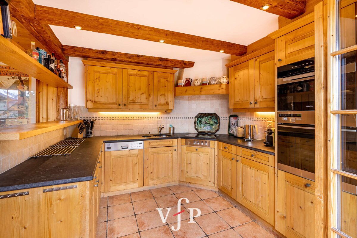 A kitchen with wooden cabinets and a sign that says vjp