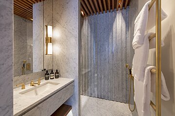 A bathroom with a sink a mirror and a shower