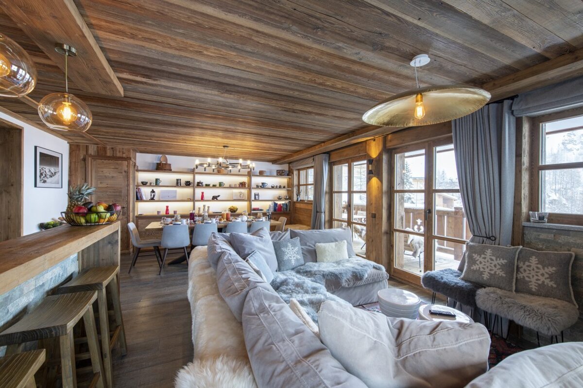 A living room with a couch and a dining table
