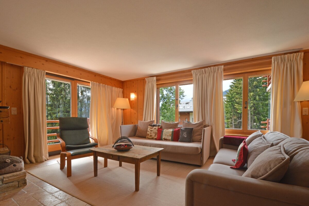 A living room with a couch a chair and a table