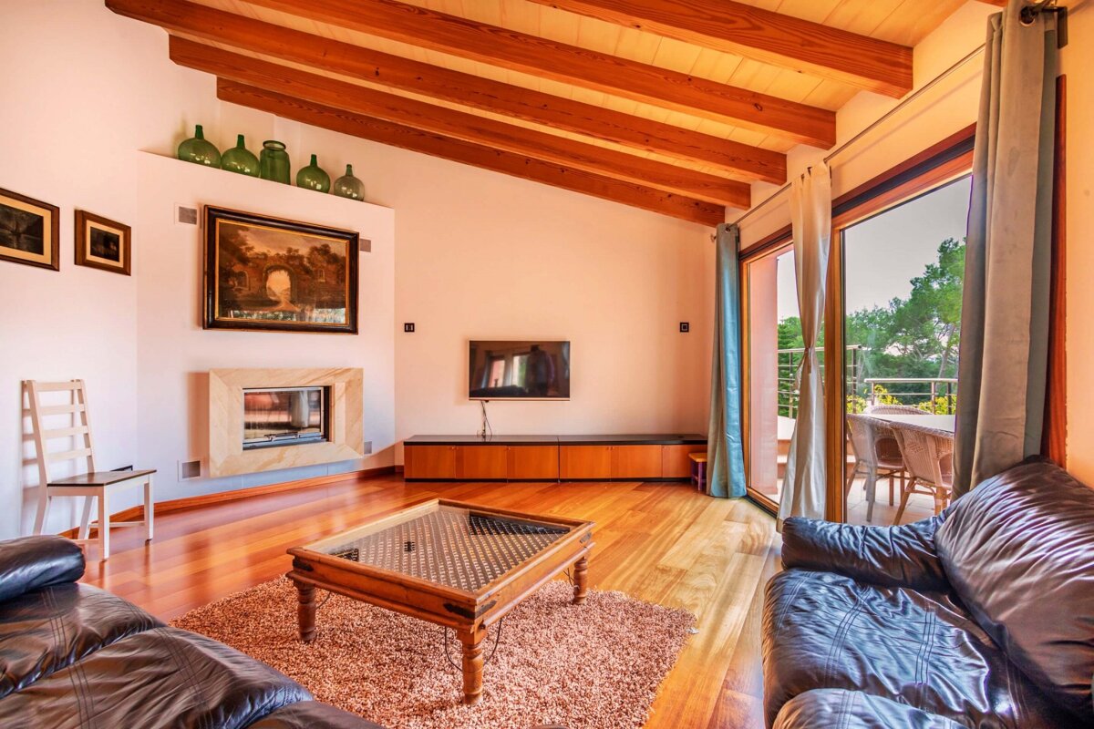 A living room with a fireplace and a television