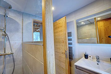 A bathroom with a sink a shower and a mirror