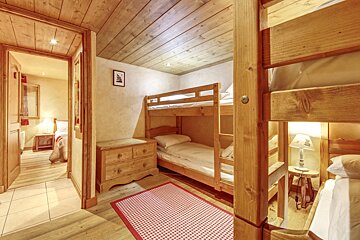 A bedroom with bunk beds and a dresser