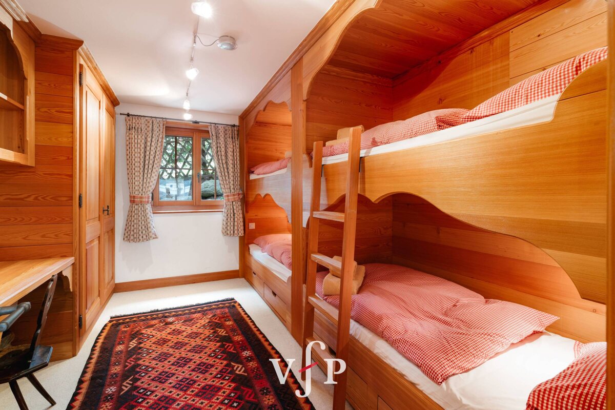 A bedroom with bunk beds and a rug that says vfp