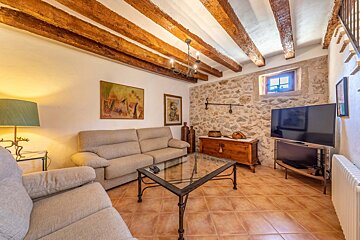 A living room with a couch and a flat screen tv