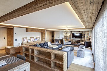 A living room with a couch and a chandelier