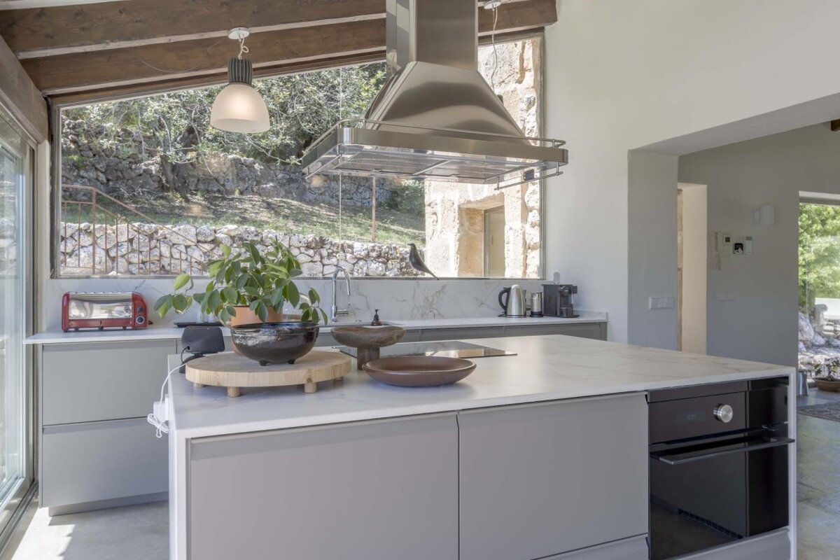 A kitchen with stainless steel appliances and a large island
