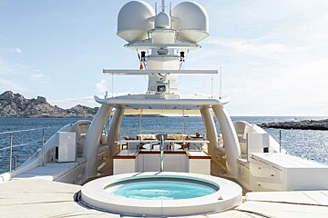 A large yacht with a jacuzzi on the deck